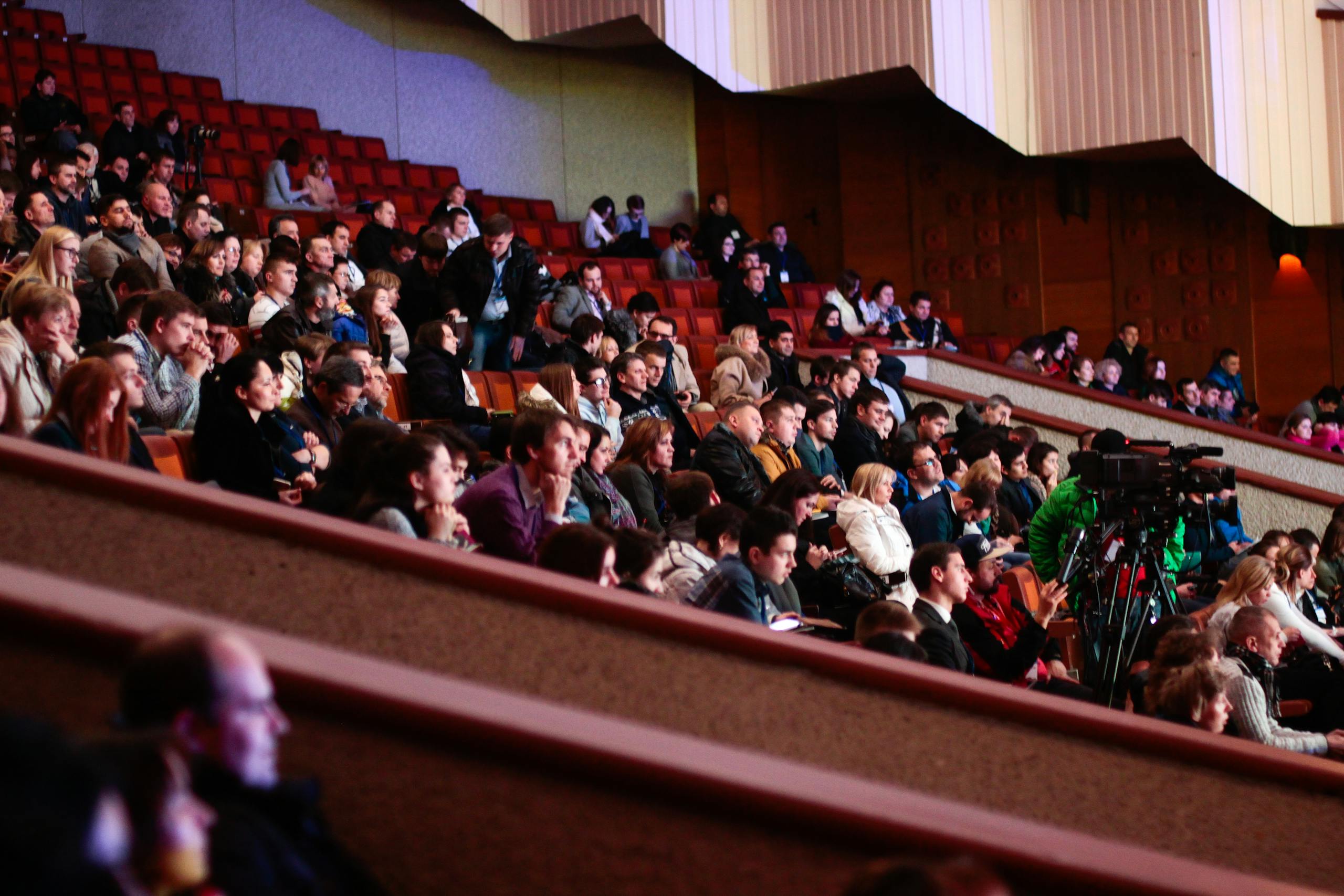 Engaged audience seated indoors, captured with a Canon camera. Ideal for event coverage visuals.