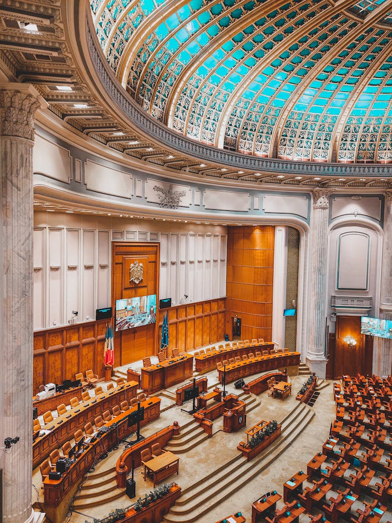 Stunning view of a grand parliamentary chamber in Europe, featuring ornate architecture and empty seating.